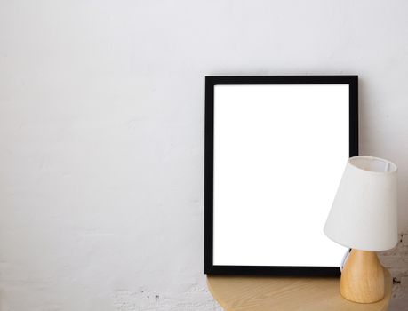 Empty black frame with place for text with lamp. Scandinavian hipster style room interior.