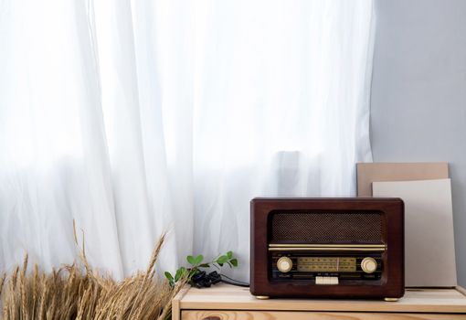 old vintage radio with shelf on the wooden cabinet