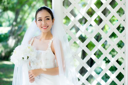 Asian bride at outdoor in a morning.