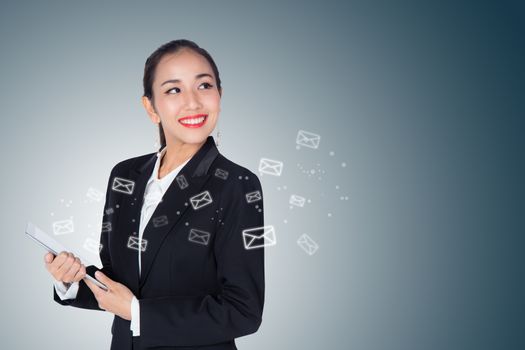 Businesswoman receive and sending email by digital tablet on blue background.