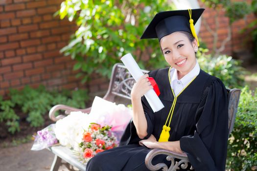 Happy graduated student girl hold certificate - congratulations of education success.