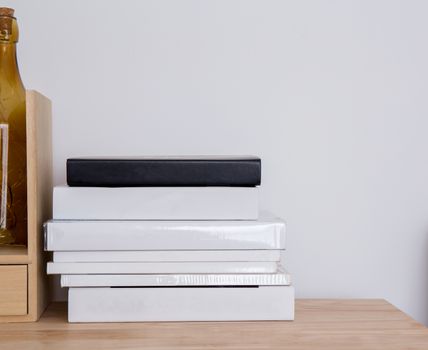 book shelf blank spines, empty binding stack on wood texture background, education concept.