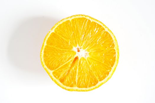 An orange sliced in half against a plain white background