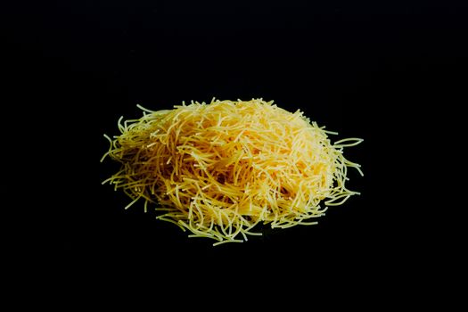 Vermicelli pasta on a black surface