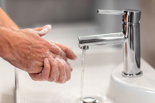 Coronavirus virus spreading prevention wash hands with soap rubbing nails and fingers washing frequently with running water or using hand sanitizer gel.