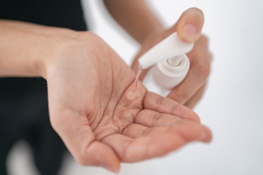 Hand sanitizer Coronavirus spreading COVID-19 prevention alcohol gel rub for hand hygiene corona virus protection. Woman using soap to clean hands.