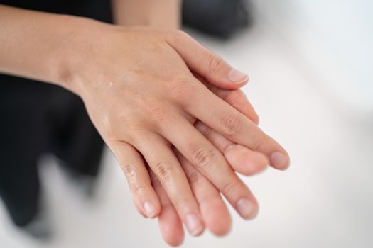 Hand sanitizer Corona virus COVID-19 prevention alcohol gel rub for hand hygiene prevention. Woman rubbing soap in palms to clean hands.