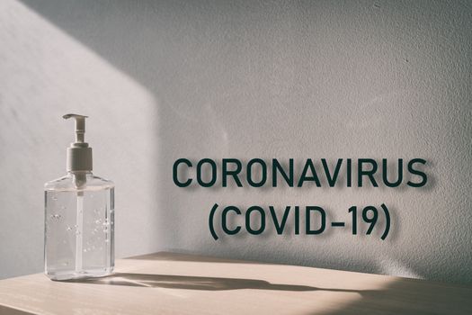 Coronavirus (COVID-19) text sign with hand sanitizer bottle background for global pandemic of corona virus outbreak.