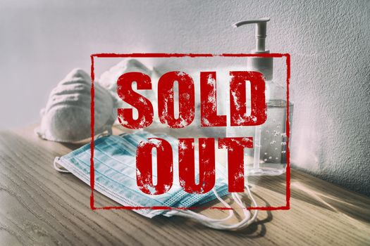 COVID-19 SOLD OUT red text SIGN of medical supplies at store. Coronavirus panic buying shortage of sanitizing products hand sanitizer gel bottles, masks, healthcare supply stockpiling problem.