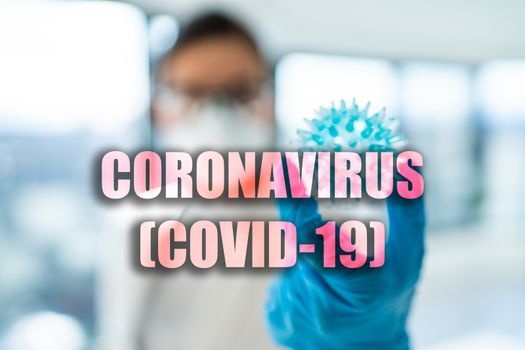CORONAVIRUS COVID-19 virus model medical researcher blurry background.