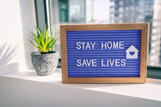 COVID-19 Coronavirus STAY HOME SAVE LIVES viral social media message sign with text for social distancing awareness. COVID-19 staying at home window background. Flatten the curve.