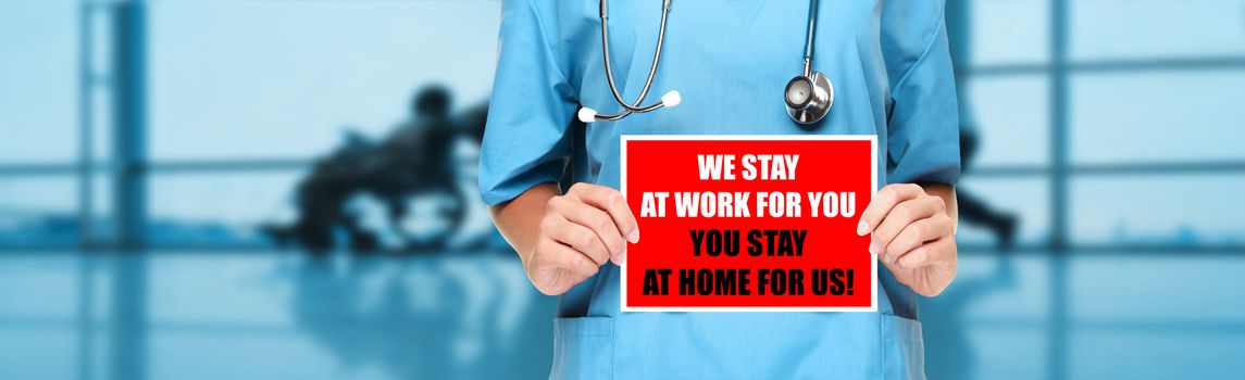 COVID-19 Social distancing quote medical nurse promoting staying at home to help workers. Coronavirus doctor holding sign in hospital background. Panoramic corona virus sign banner with text title.