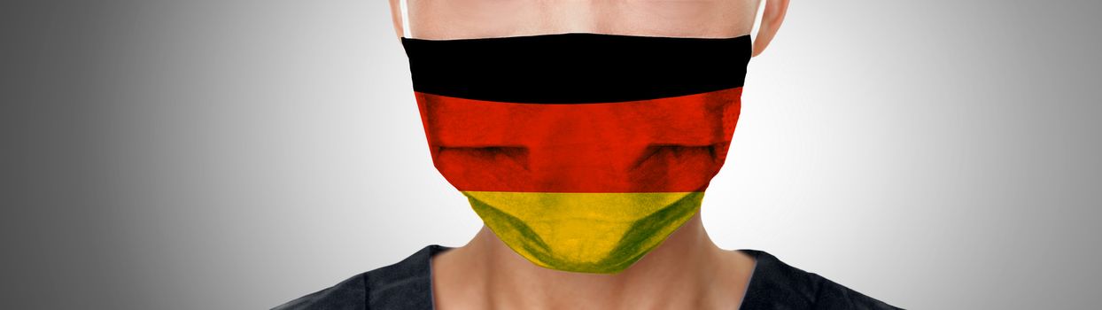 German COVID-19 masks flag on PPE doctor wearing mask panoramic banner. Coronavirus pandemic outbreak in Germany. Graphic design illustration print on medical personal protective equipment.