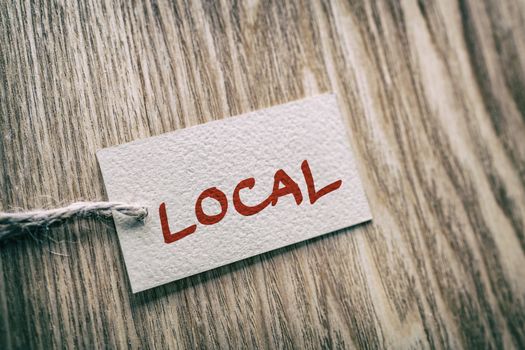 LOCAL handwritten paper gift box label on brown wood texture background , for buying locally small economy.