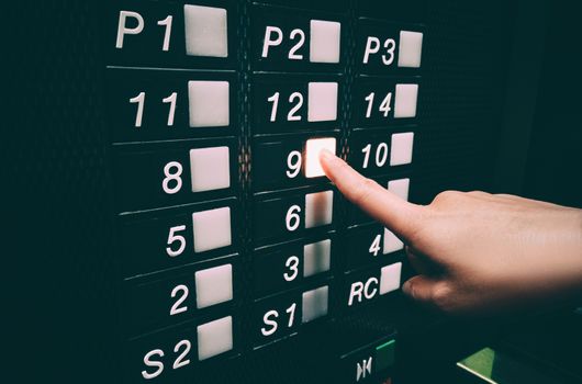 Pressing elevator button with hands, touching public surface with germs, personal hand hygiene care for COVID-19 coronavirus prevention.