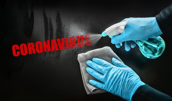 Coronavirus disinfecting surfaces cleaning home cleaning spraying aways red text with sanitizing spray bottle against COVID-19 wearing blue gloves. Sanitize surface prevention.