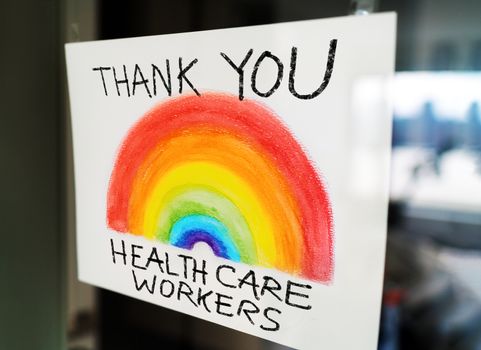 THANK YOU Healthcare workers child's painting hanging at window as appreciation support message for doctors and nurses fighting COVID-19 at hospitals.