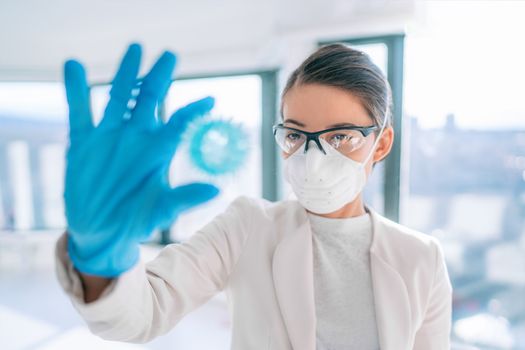 Coronavirus lab research woman researcher finding vaccine cure holding corona virus blue model of COVID-19.