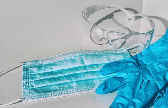 Mask, gloves, glasses PPE for COVID-19 protection healthcare workers. Shortage of personal protective equipment for coronavirus.