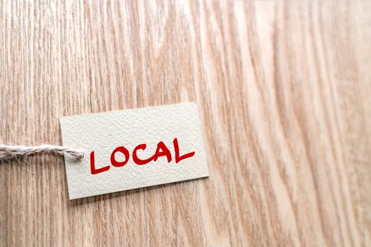 LOCAL handwritten paper gift box label on brown wood texture background , for buying locally small economy.