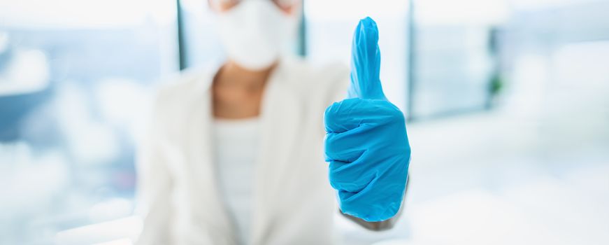 Coronavirus success happy news lab researcher doing thumbs up with medical gloves for vaccine. PPE for COVID-19 healthcare banner panoramic.