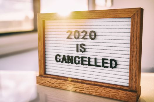 COVID-19 Coronavirus Quote 2020 IS CANCELLED written on white felt letter board sign. Funny message for public events, outdoor gatherings.