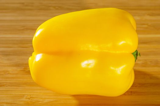Yellow pepper on a wooden background