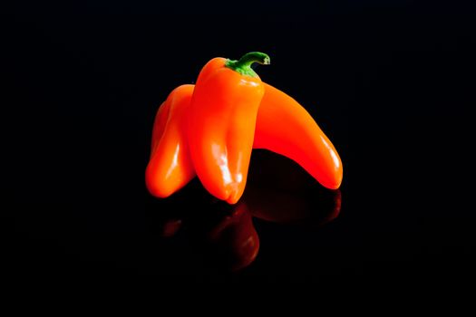Small peppers on a black surface