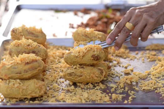 Battered and Deep-Fried Unripe Rice and Grated Coconut Banana Rollsy, Thai dessert.