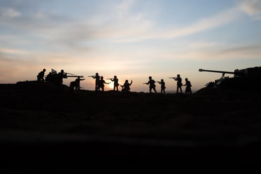 War Concept. Military silhouettes fighting scene on war fog sky background, World War Soldiers Silhouette Below Cloudy Skyline sunset. Selective focus