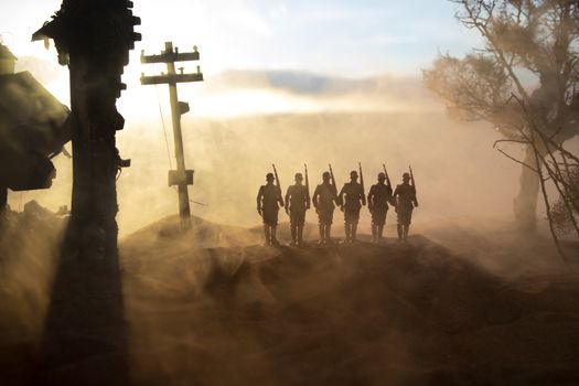 War Concept. Military silhouettes fighting scene on war fog sky background, World War Soldiers Silhouette Below Cloudy Skyline At sunset. Battle in ruined city. Selective focus