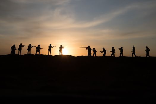 War Concept. Military silhouettes fighting scene on war fog sky background, World War Soldiers Silhouette Below Cloudy Skyline sunset. Selective focus