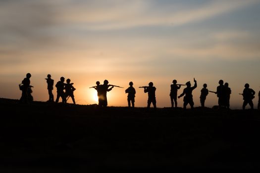 War Concept. Military silhouettes fighting scene on war fog sky background, World War Soldiers Silhouette Below Cloudy Skyline sunset. Selective focus