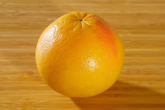 Red grapefruit on a wooden background