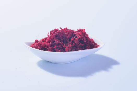 Horseradish sauce (with beet) - A traditional Jewish Passover dish. In a white plate on white background