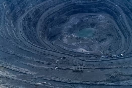 A big quarry for gold mining. The technique is in the car.