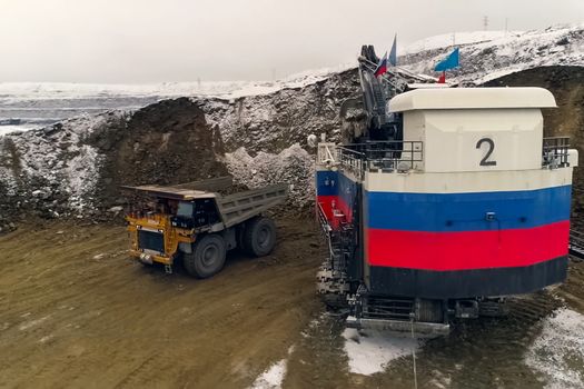 A big quarry for gold mining. The technique is in the car.