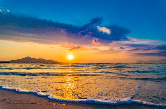 Idyllic evening twilight on the beach with soft sea water wave