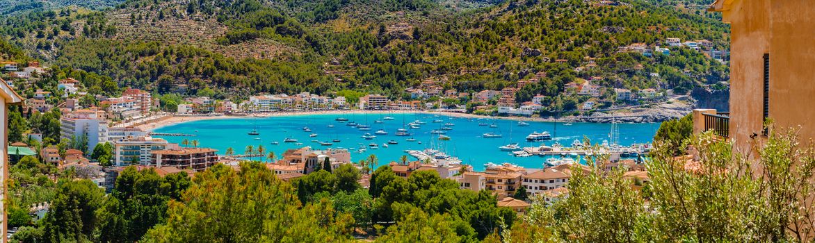 Marina of Port de Soller with view of beach and boats at bay, Mallorca, Balearic Islands