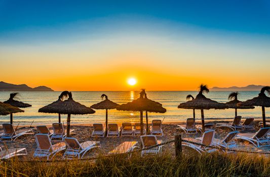 Beautiful sunset with orange sun over horizon on seaside beach