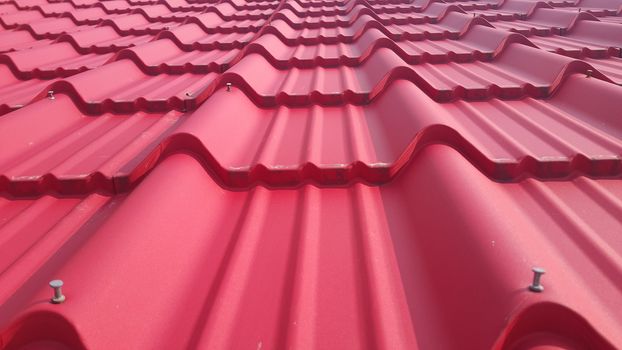 Closeup of red color roof tiles. Background texture for rooftop tiles.