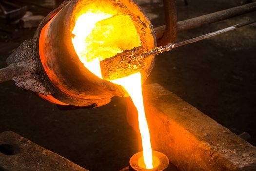 A large bowl of molten metal at a steel mill. Steel production.