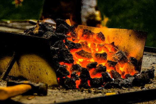 Hot ore in a steel trough. A metal smelting plant.