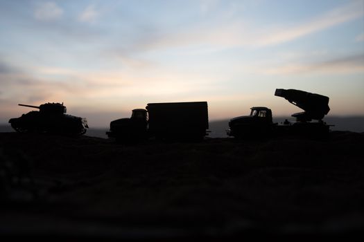 War Concept. Military silhouettes fighting scene on war fog sky background, World War Soldiers Silhouette Below Cloudy Skyline sunset. Selective focus