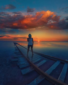 Male on beauty sunset on salty lake in Altay, Siberia, Russia