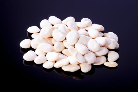 Big white beans on a black background