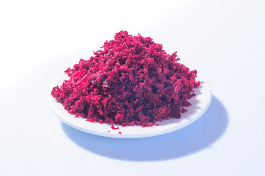 Horseradish sauce (with beet) - A traditional Jewish Passover dish. In a white plate on white background