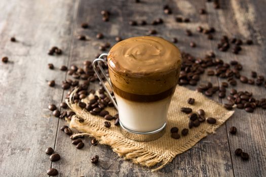 Creamy iced dalgona coffee on wooden table
