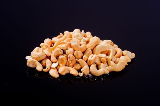 Salted Cashew Nuts on a black background