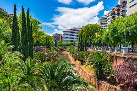 Citycape with water canal stream and park in Palma de Majorca, Spain